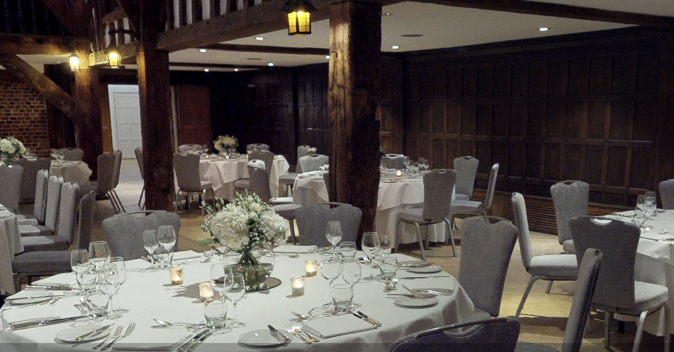 Elegant dining setup in The Tithe Barn, ideal for weddings and corporate events.
