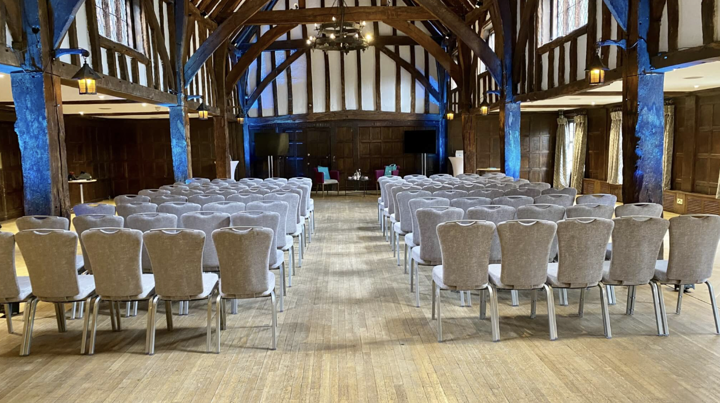 Tithe Barn event space with elegant chairs, ideal for meetings and presentations.