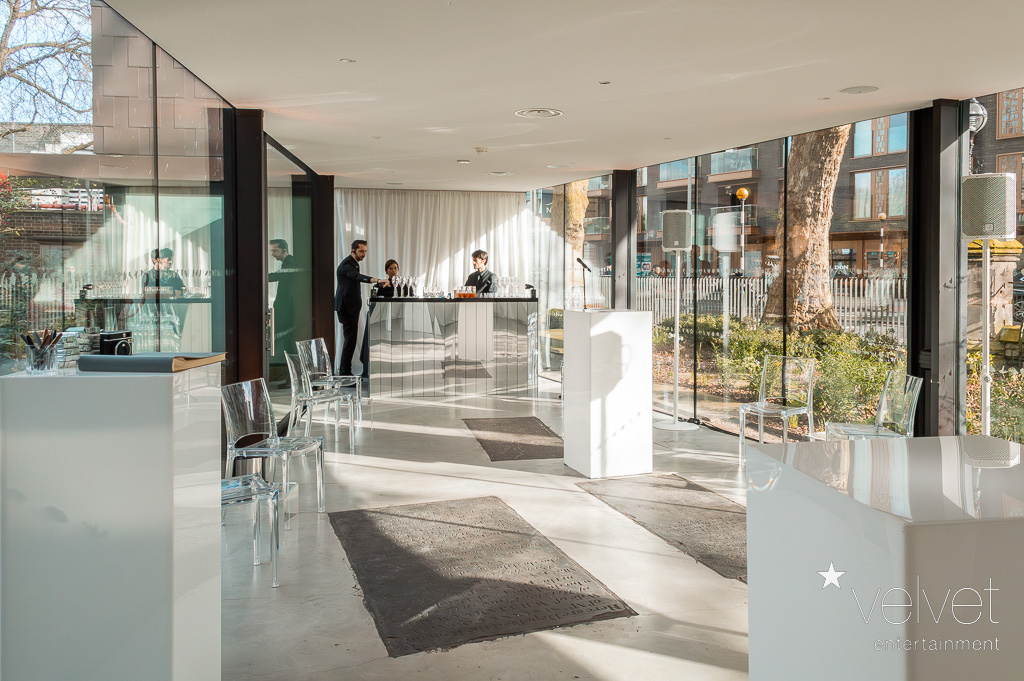 Modern event space with glass walls, ideal for corporate meetings and upscale events.