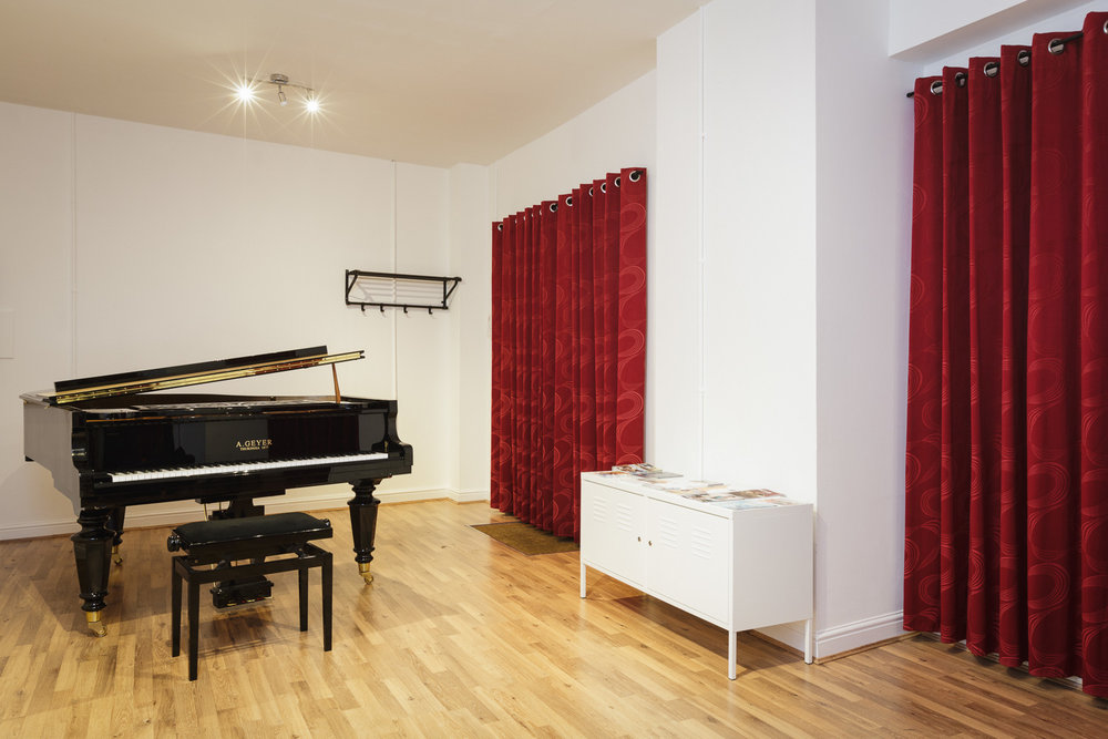 Versatile Vanbrugh Studio venue with grand piano for elegant events and workshops.