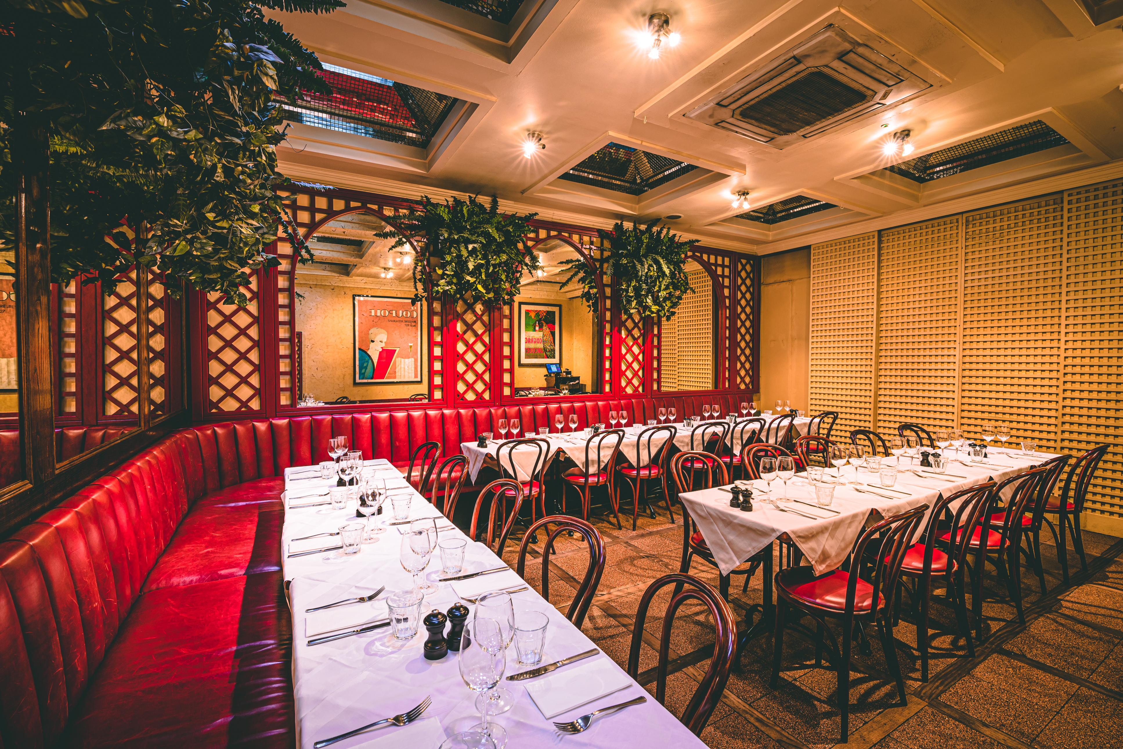 Elegant private dining room with red banquette for intimate gatherings and corporate events.