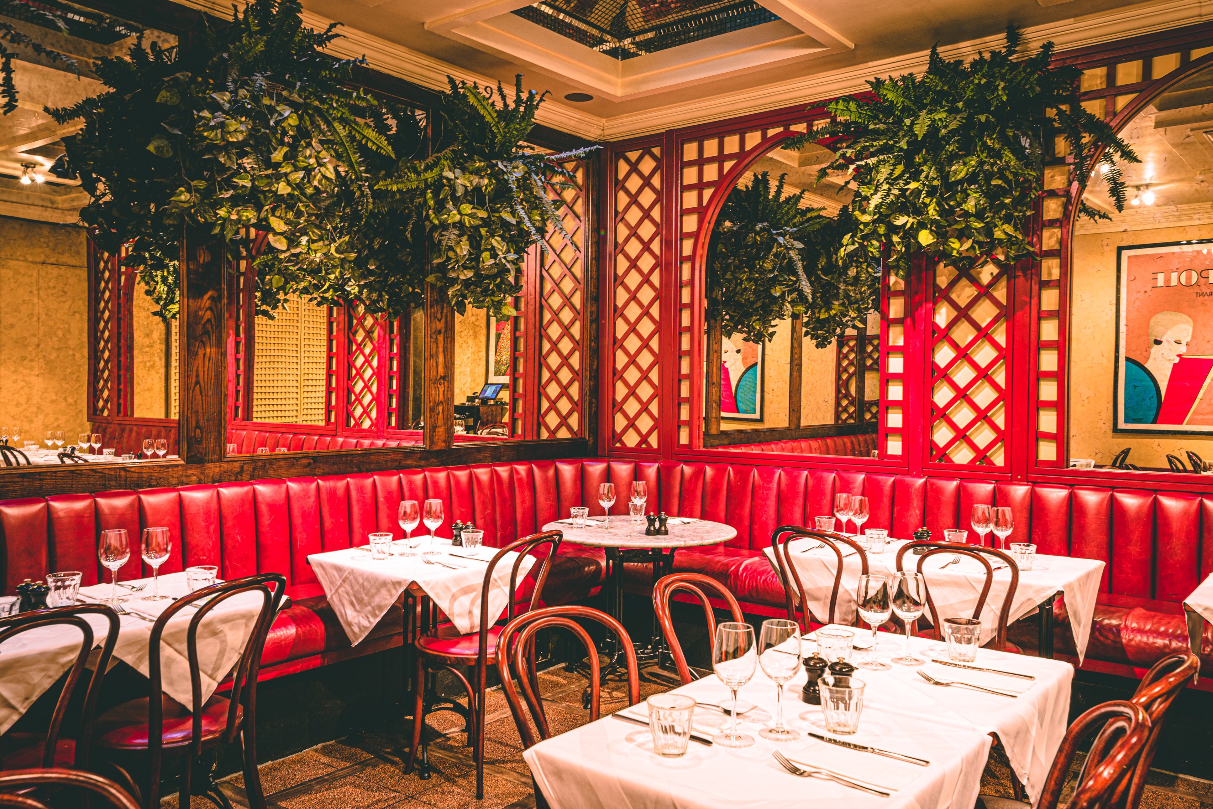 Private room in Palm Court Brasserie with red banquettes, ideal for corporate events and gatherings.