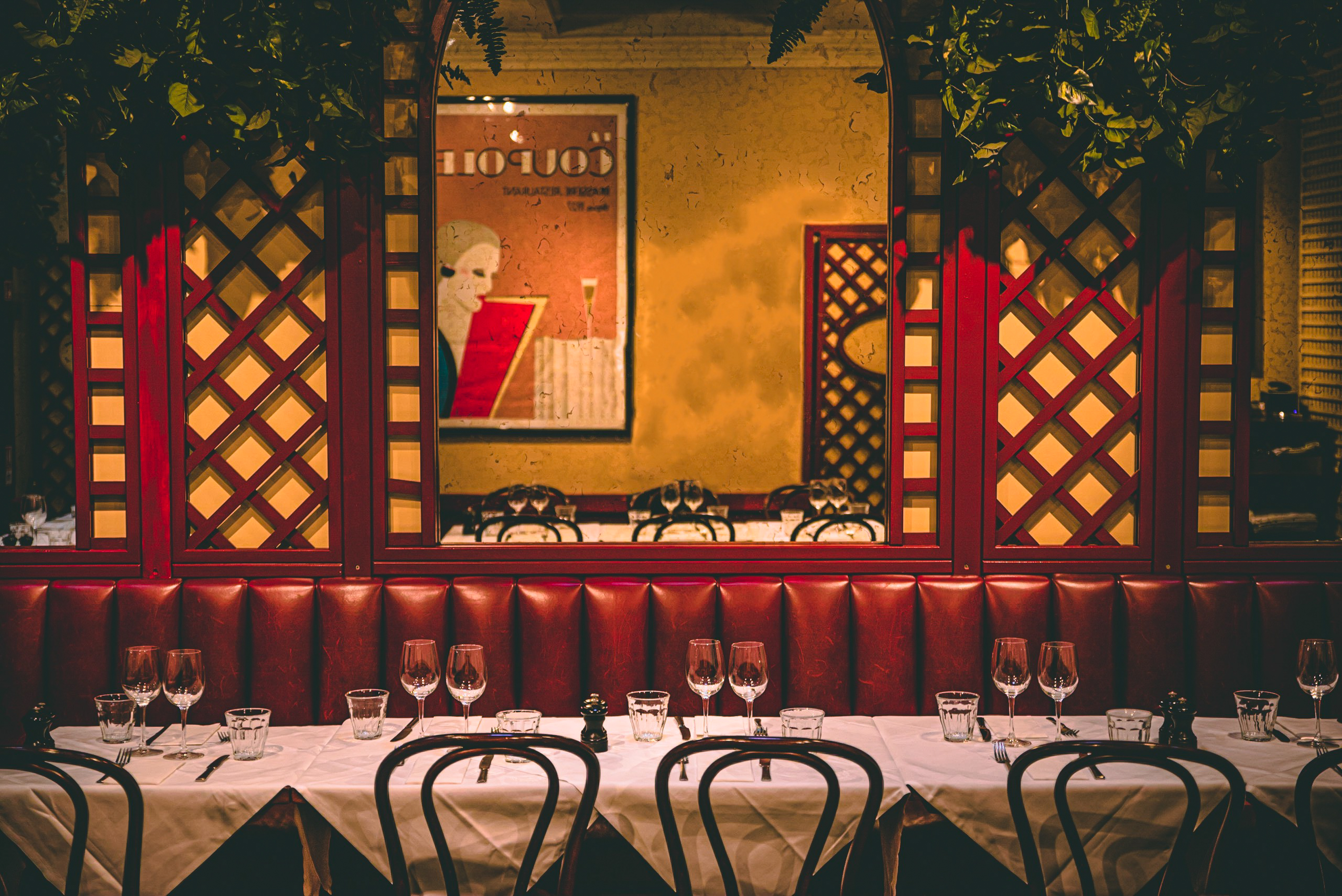 Private room in Palm Court Brasserie with red upholstery, ideal for intimate events.