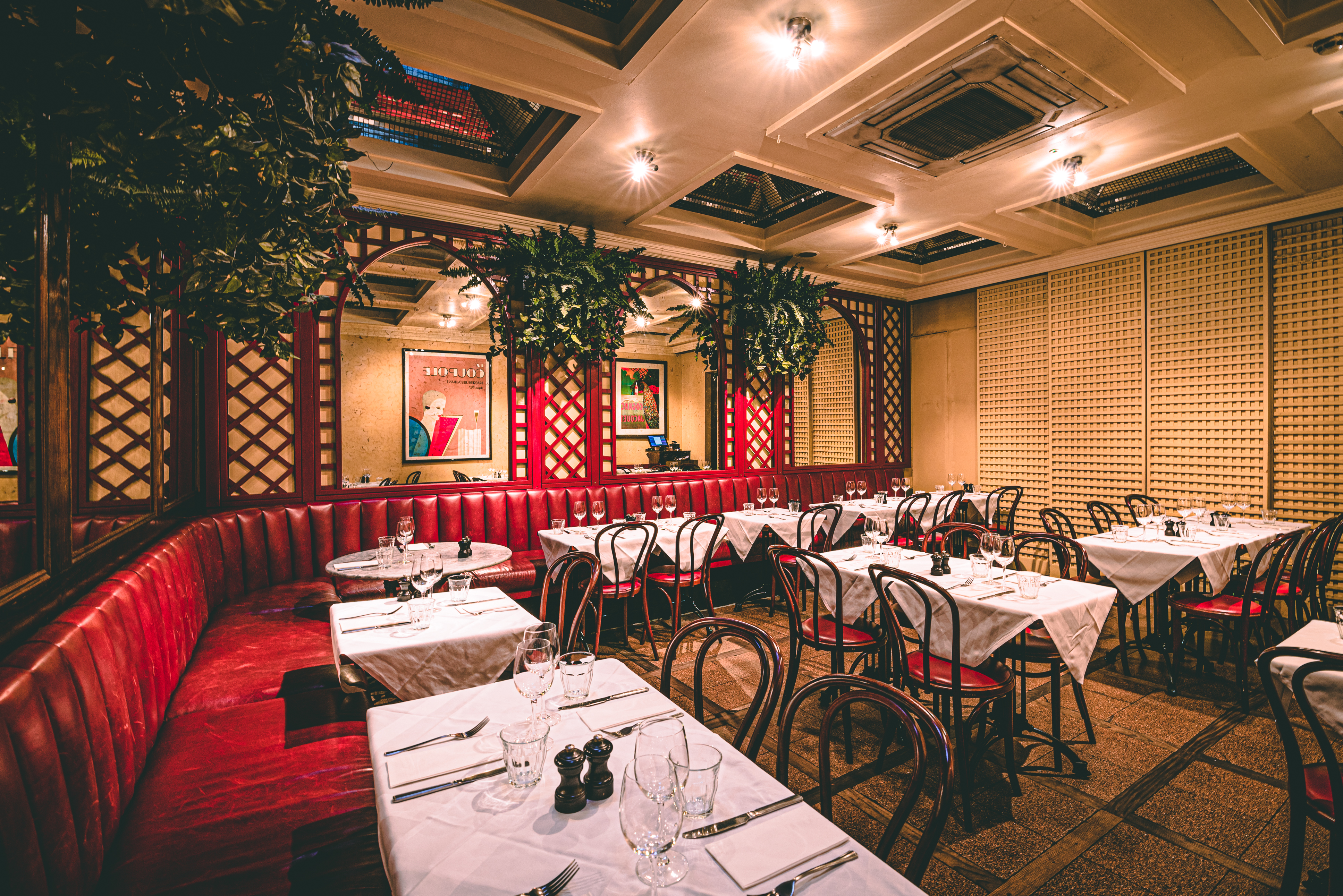 Private room with cozy red banquette, ideal for intimate gatherings and corporate events.