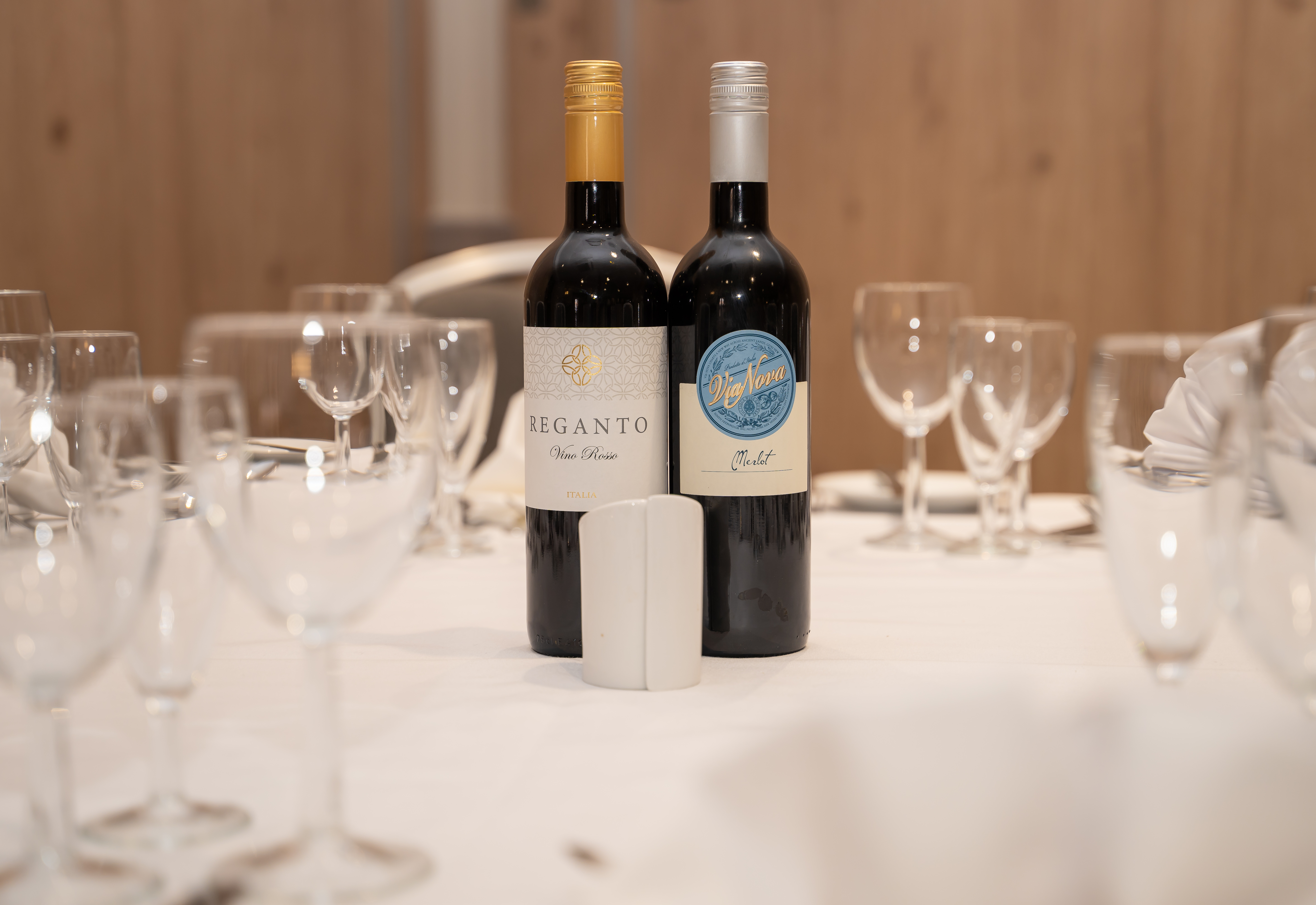 Oadby Suite dining table with wine bottles, perfect for corporate events and formal dinners.