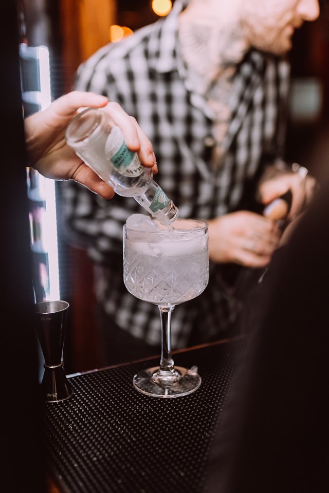 Bartender crafting a cocktail in Head of Steam Tasting Room for event catering.