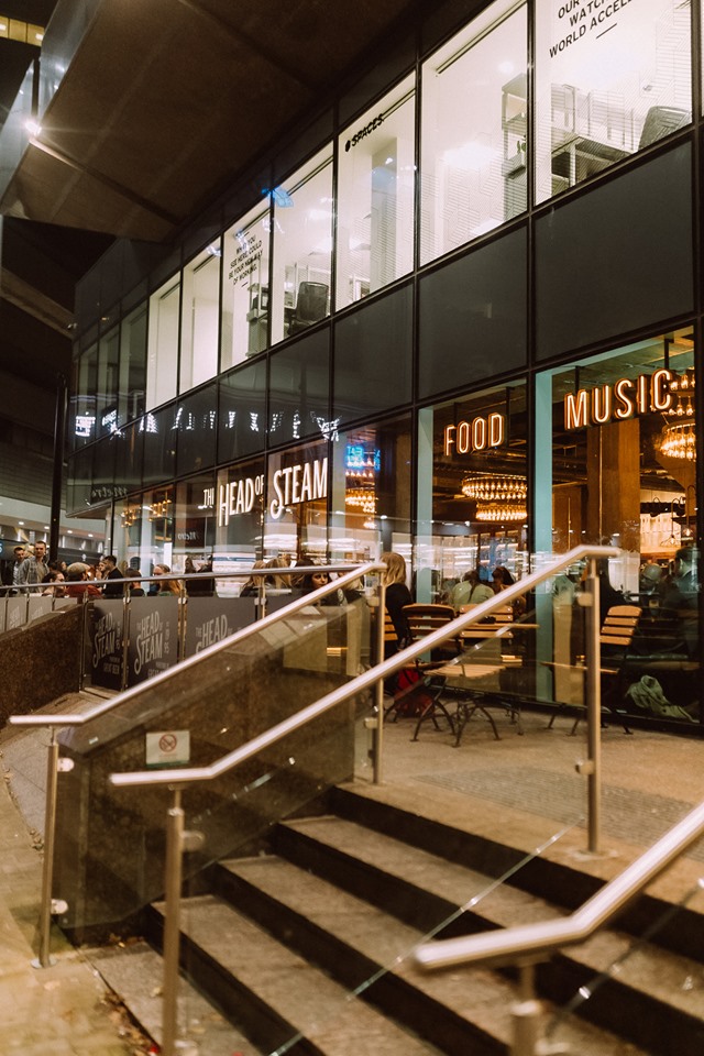 Modern event venue with large windows, ideal for networking and social gatherings.