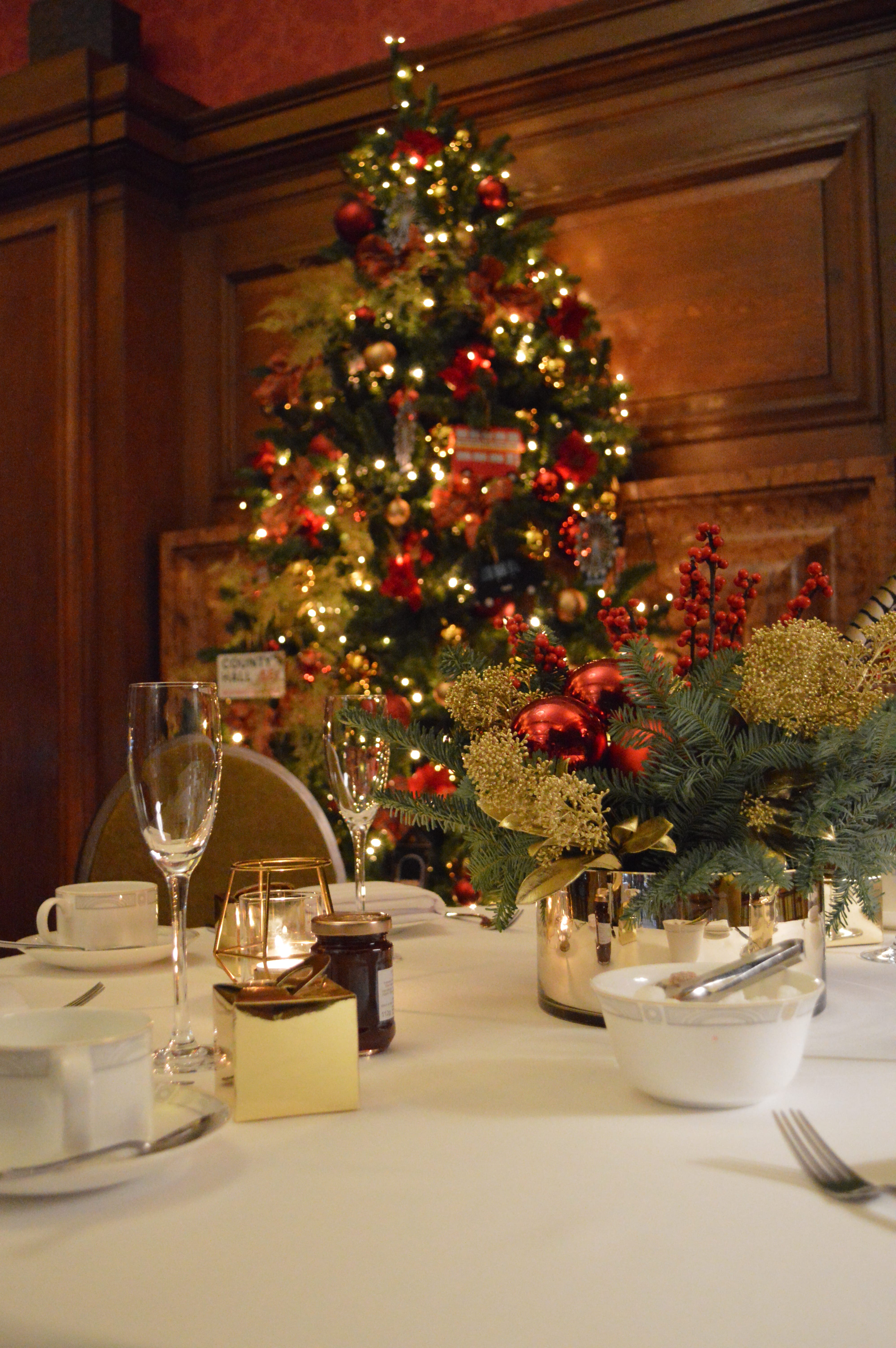 Elegant Christmas party table at London Marriott with festive decor and warm ambiance.