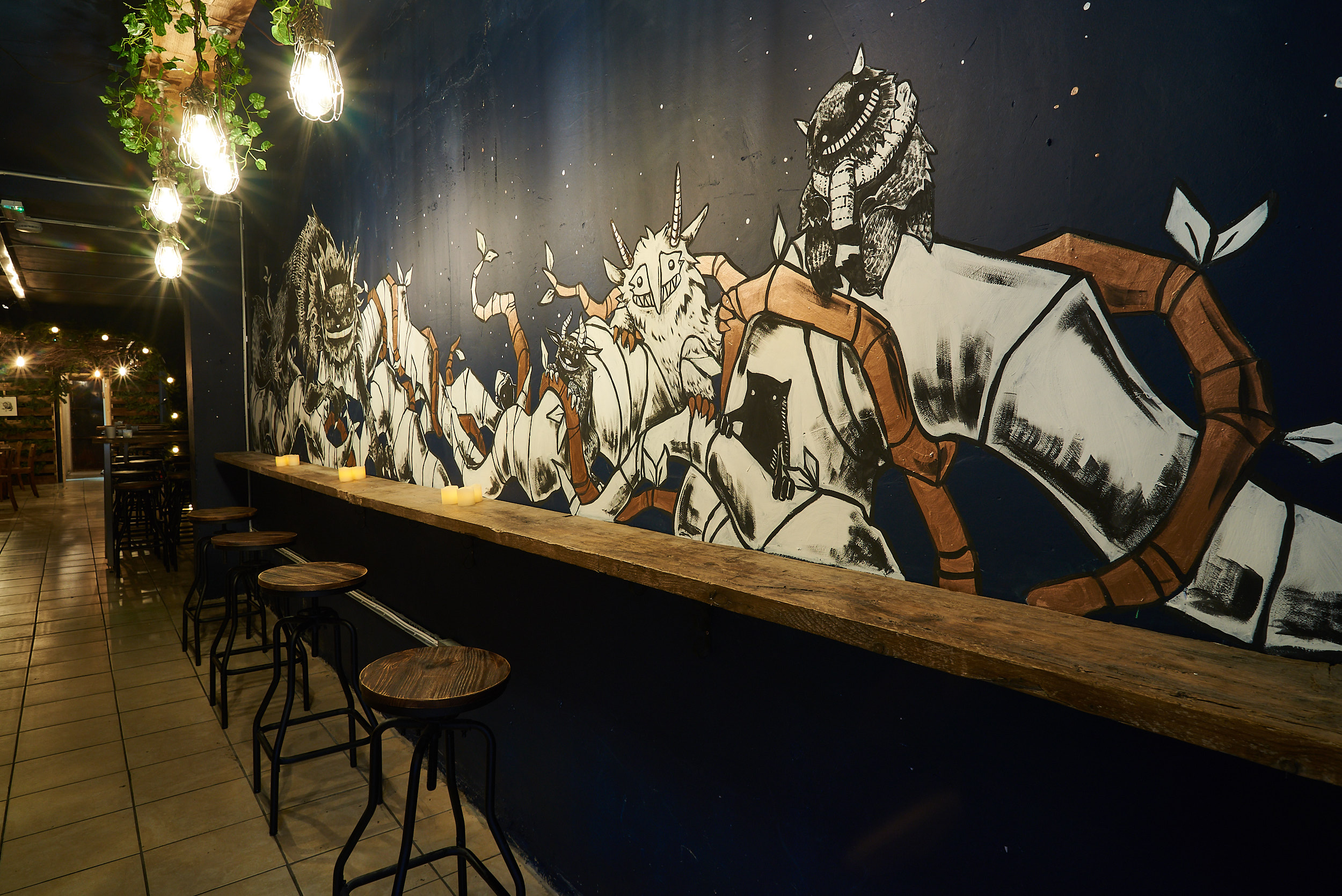 BATCH Cocktail Bar with striking mural, perfect for social events and gatherings.