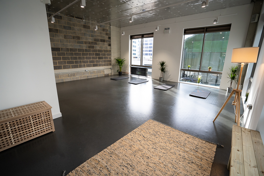 Modern event space with natural light, ideal for workshops and wellness retreats.