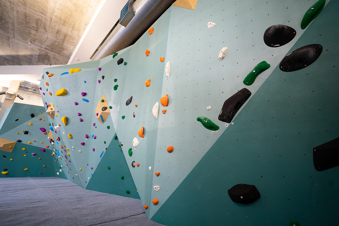 Vibrant indoor climbing wall at The Nest for team-building and active workshops.
