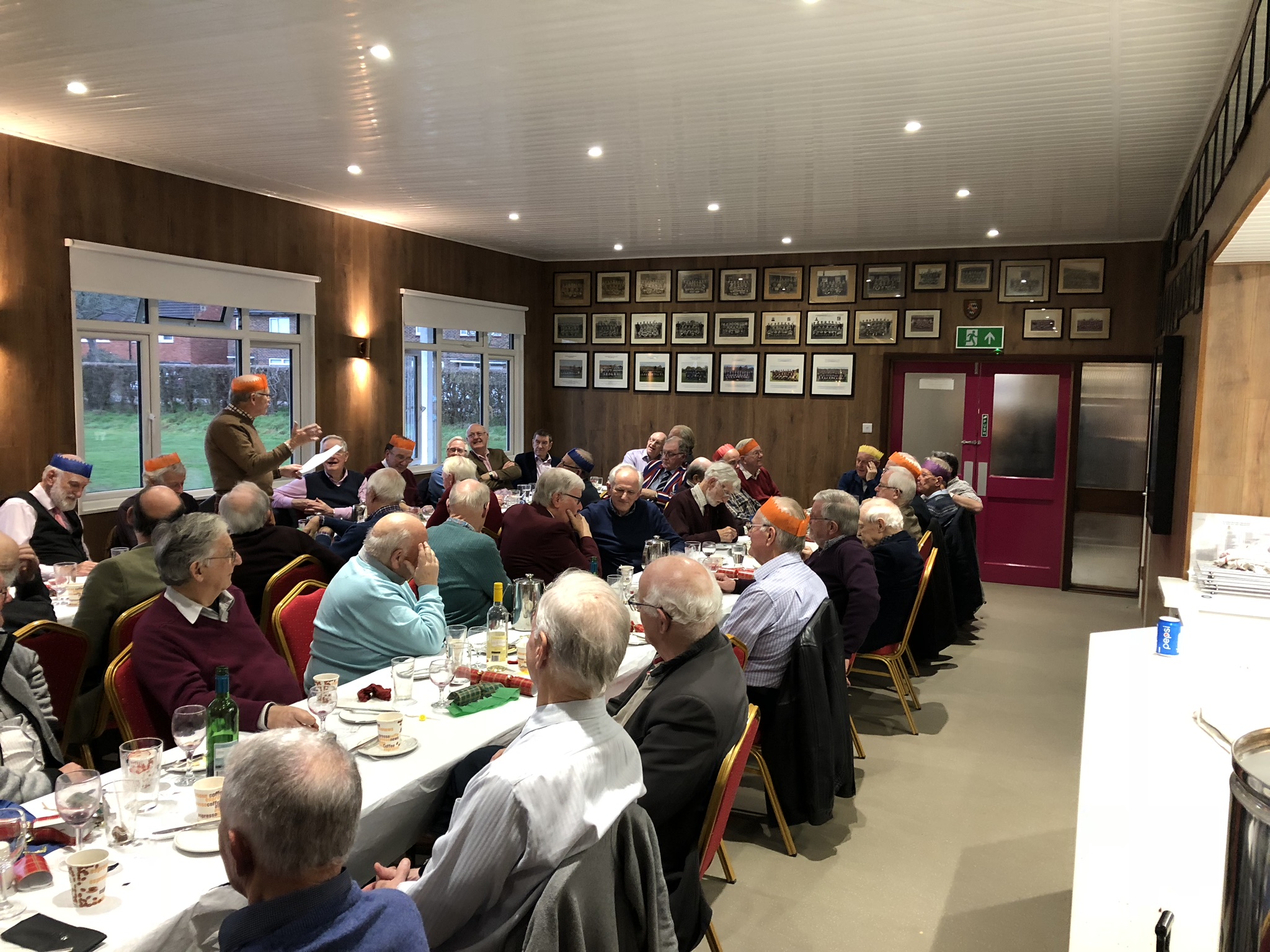 Clubhouse meeting at Old Haberdashers', cozy setting with engaging speaker.