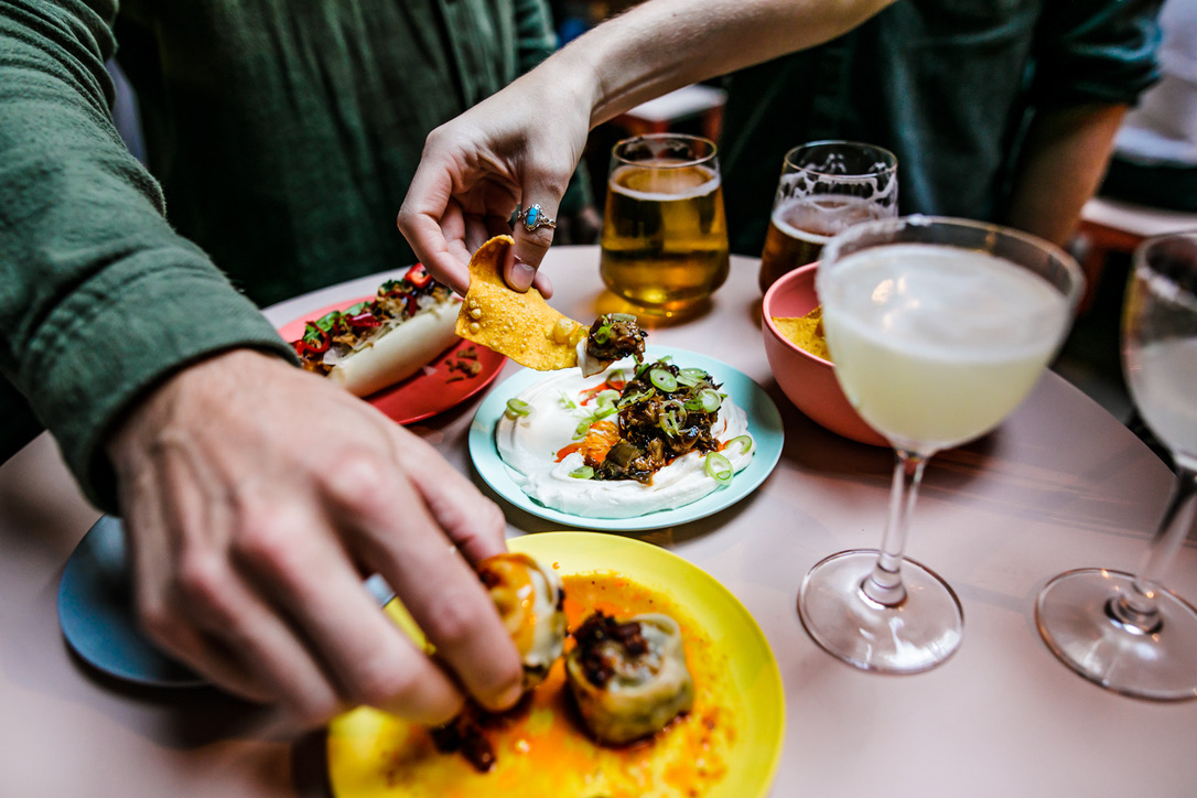 Vibrant gathering at The Market Bookshop with colorful dishes for social mixers.