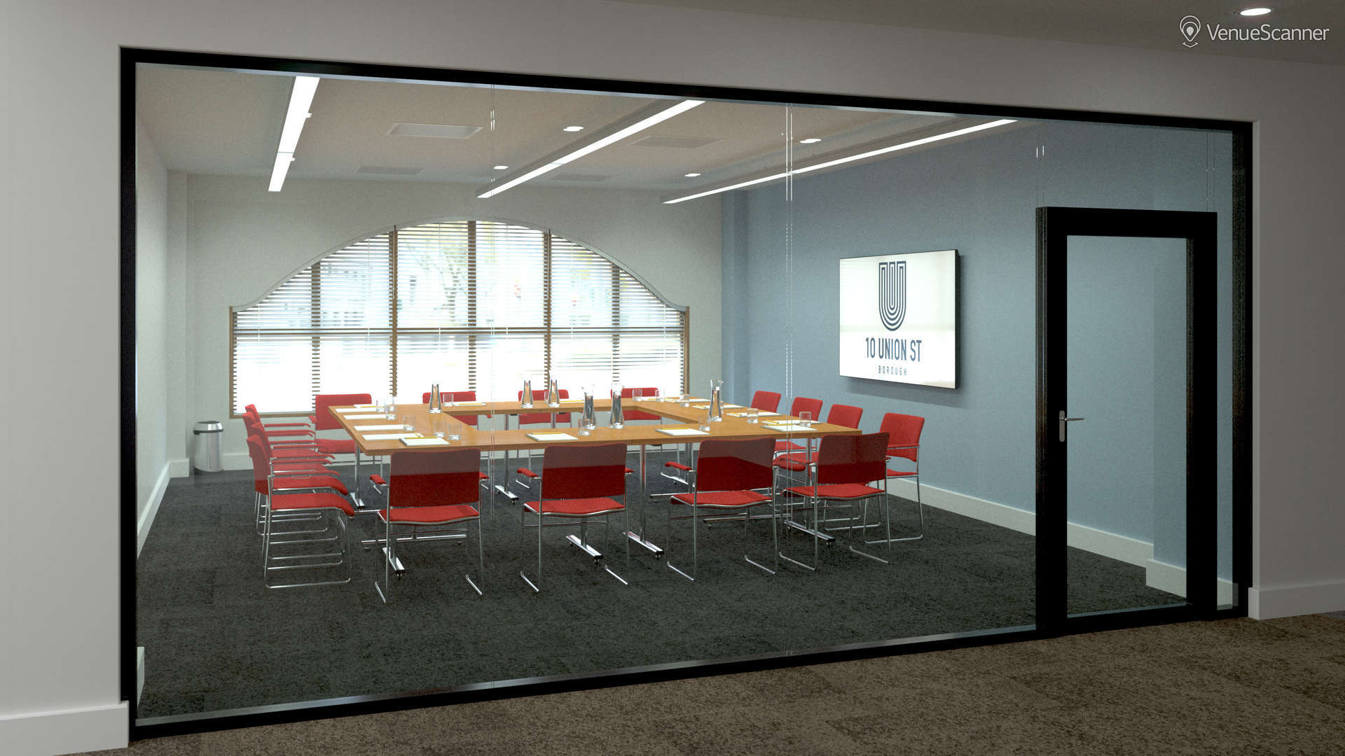 Modern conference room with large table, ideal for meetings and presentations.