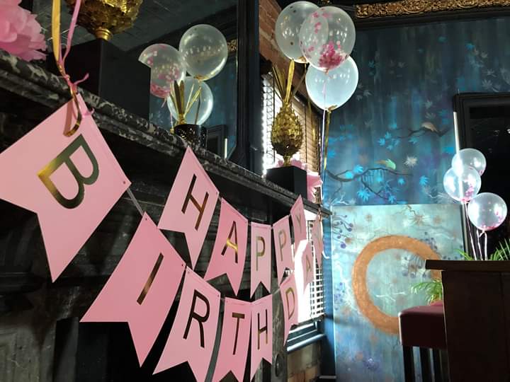 Charming birthday party setup with balloons and "Happy Birthday" banner at Stag and Antelope.
