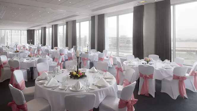 Kings Suite at Radisson Blu Liverpool, elegant wedding venue with pink sashes and natural light.