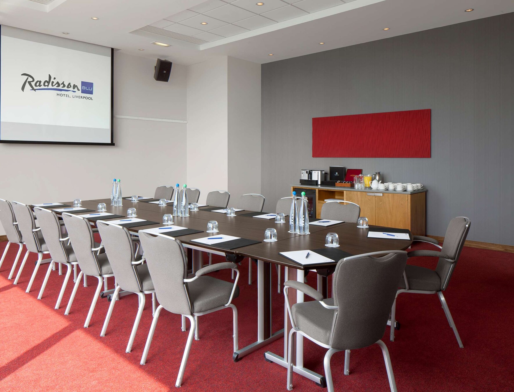 Meeting room at Radisson Blu, Liverpool, set for corporate workshops with modern decor.