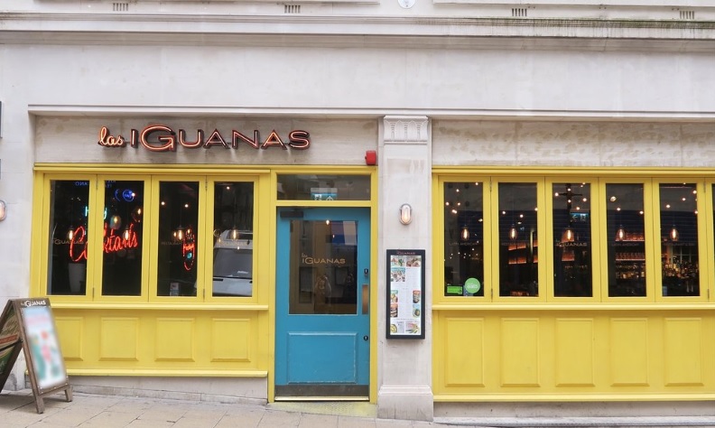 Vibrant Las Iguanas Birmingham venue with bright yellow frames, ideal for casual gatherings.
