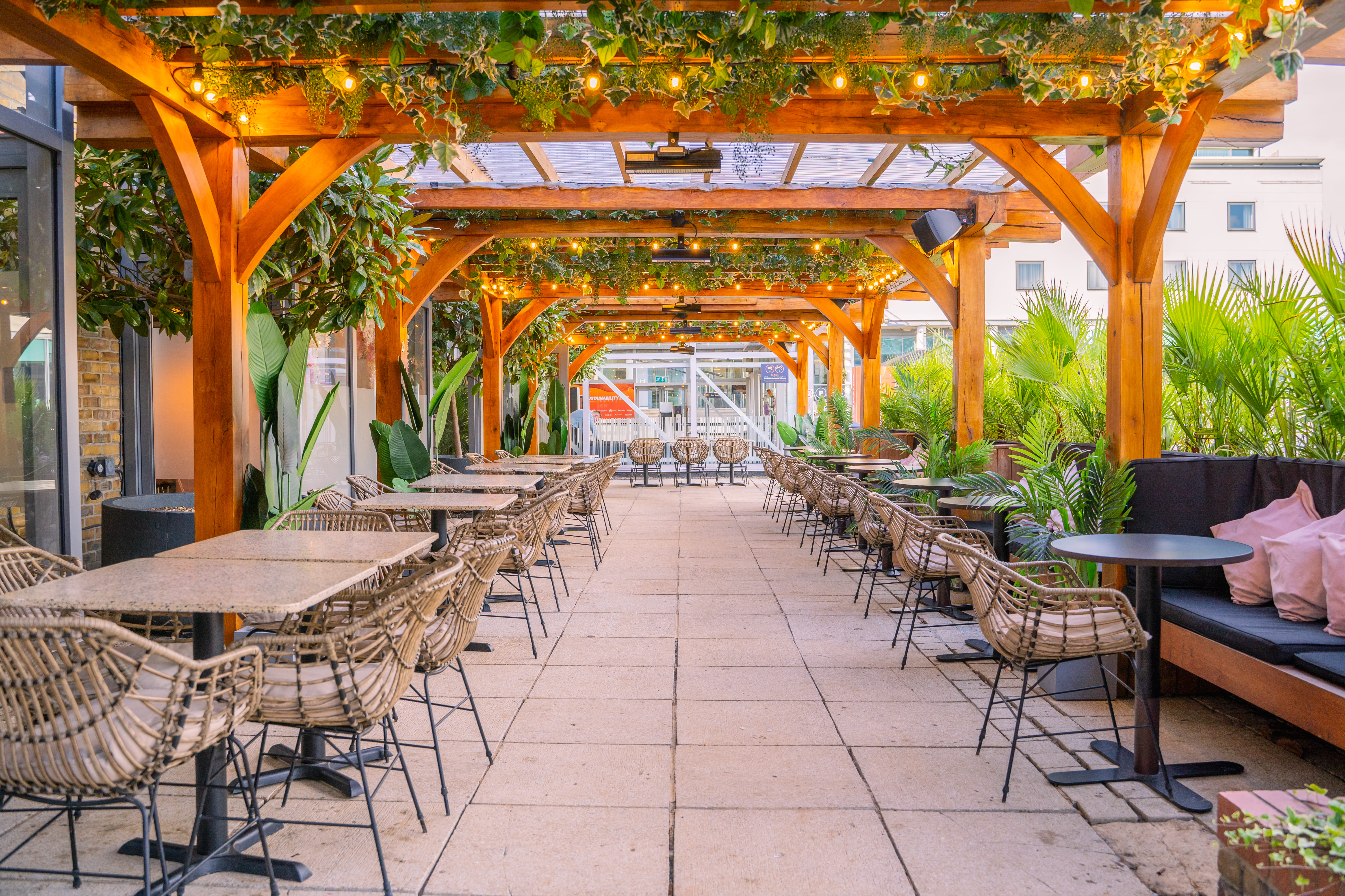 Outdoor venue with pergola, ideal for networking receptions and intimate dinners.