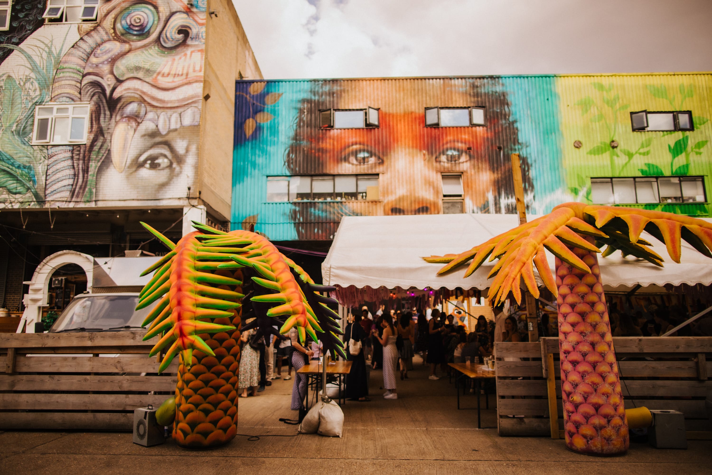 Vibrant outdoor event space at 90 Bar & Kitchen with oversized pineapples, ideal for gatherings.