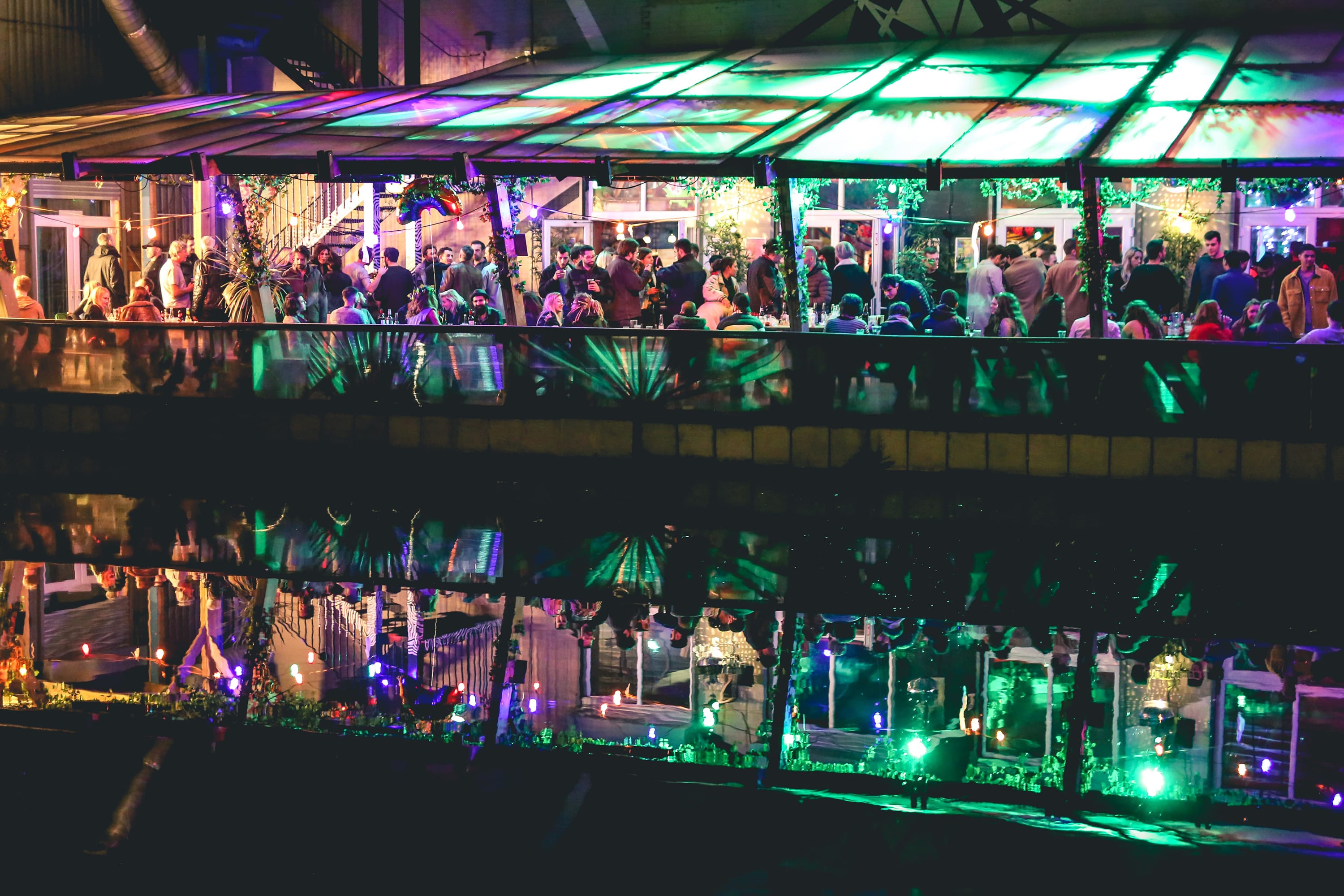 Vibrant event space at 90 Bar & Kitchen with colorful lighting for networking gatherings.