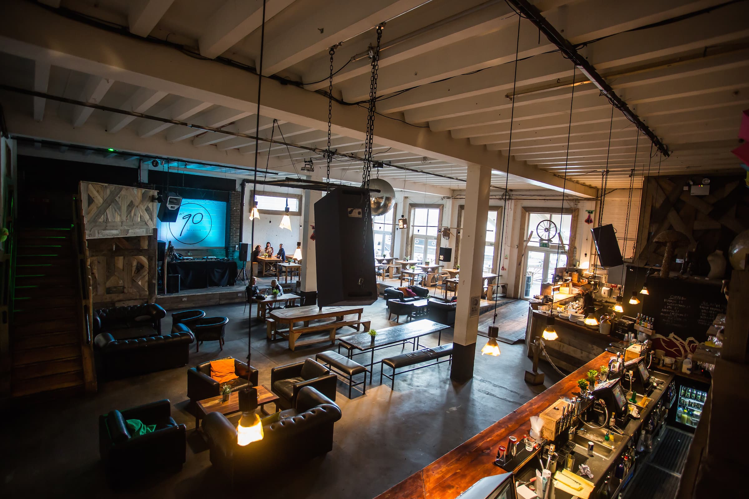 90 Bar & Kitchen event space with modern decor, ideal for networking and gatherings.