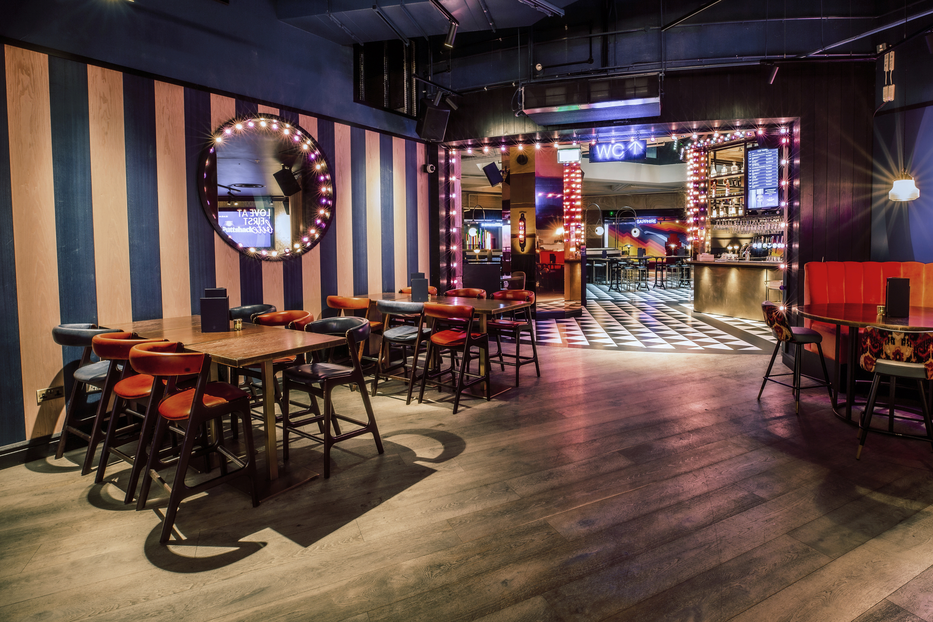 Vibrant event space at Puttshack Bank with stylish seating for networking and gatherings.