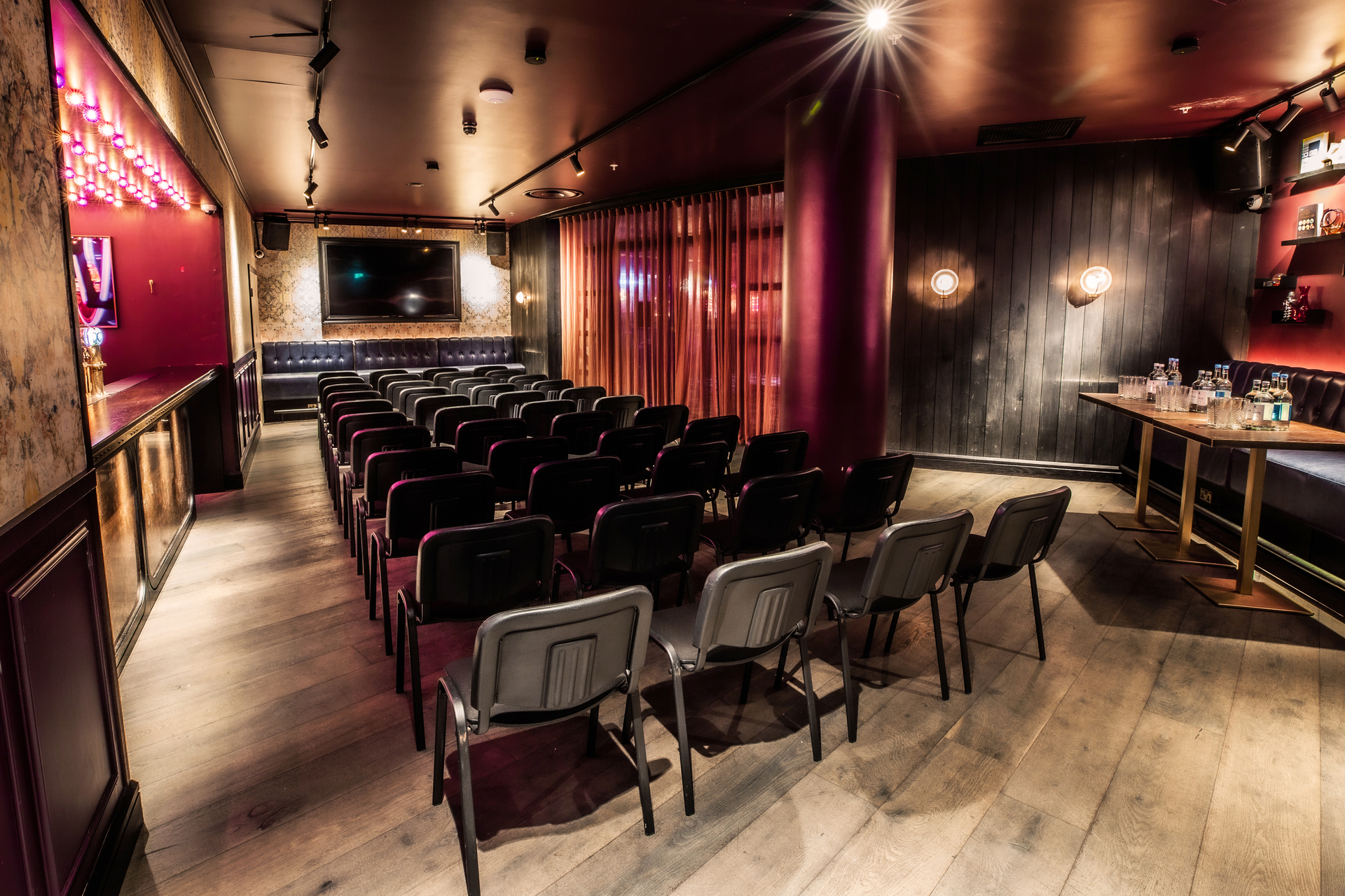 Stylish event space at Puttshack Bank for presentations and seminars.