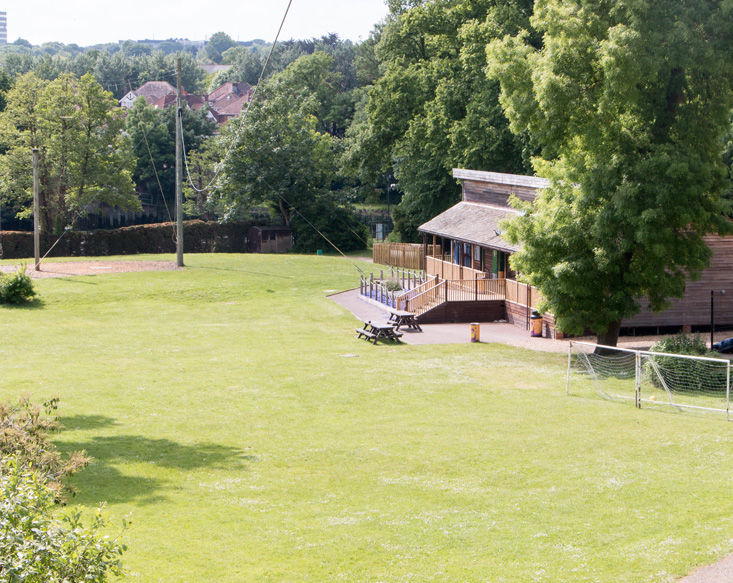 Stoneham Lodge outdoor venue with lush lawn, ideal for events and team-building activities.