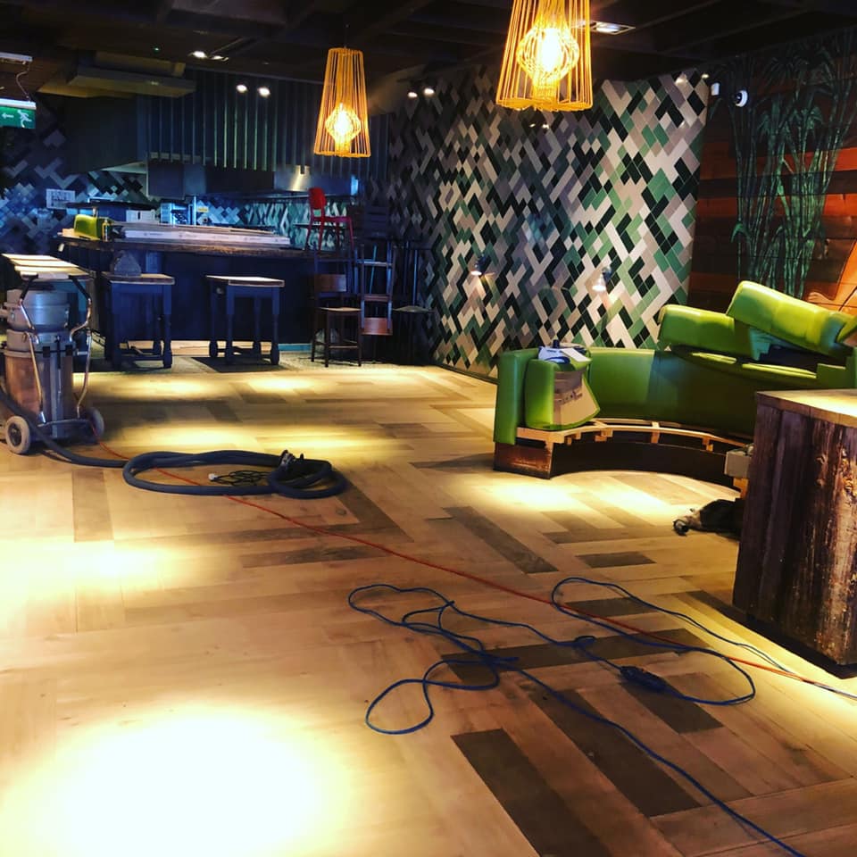 Pre-event setup at Las Iguanas Cardiff with vibrant green furniture for meetings and events.