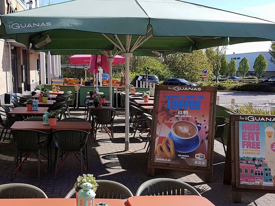 Outdoor dining area at Las Iguanas Cheshire with vibrant umbrellas for networking events.