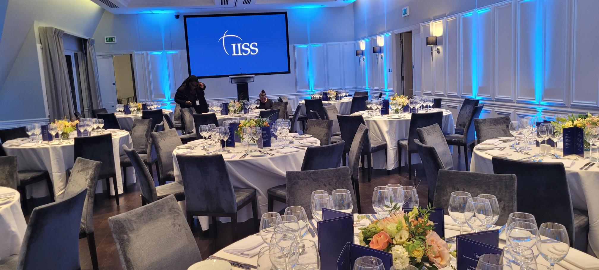 Lee Kuan Yew Room set for formal dinner with elegant tables and blue lighting.