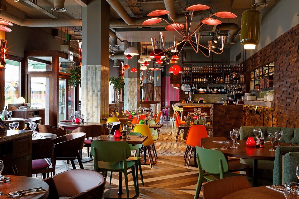 Vibrant Las Iguanas Kingston venue with colorful chairs for casual events and meetings.