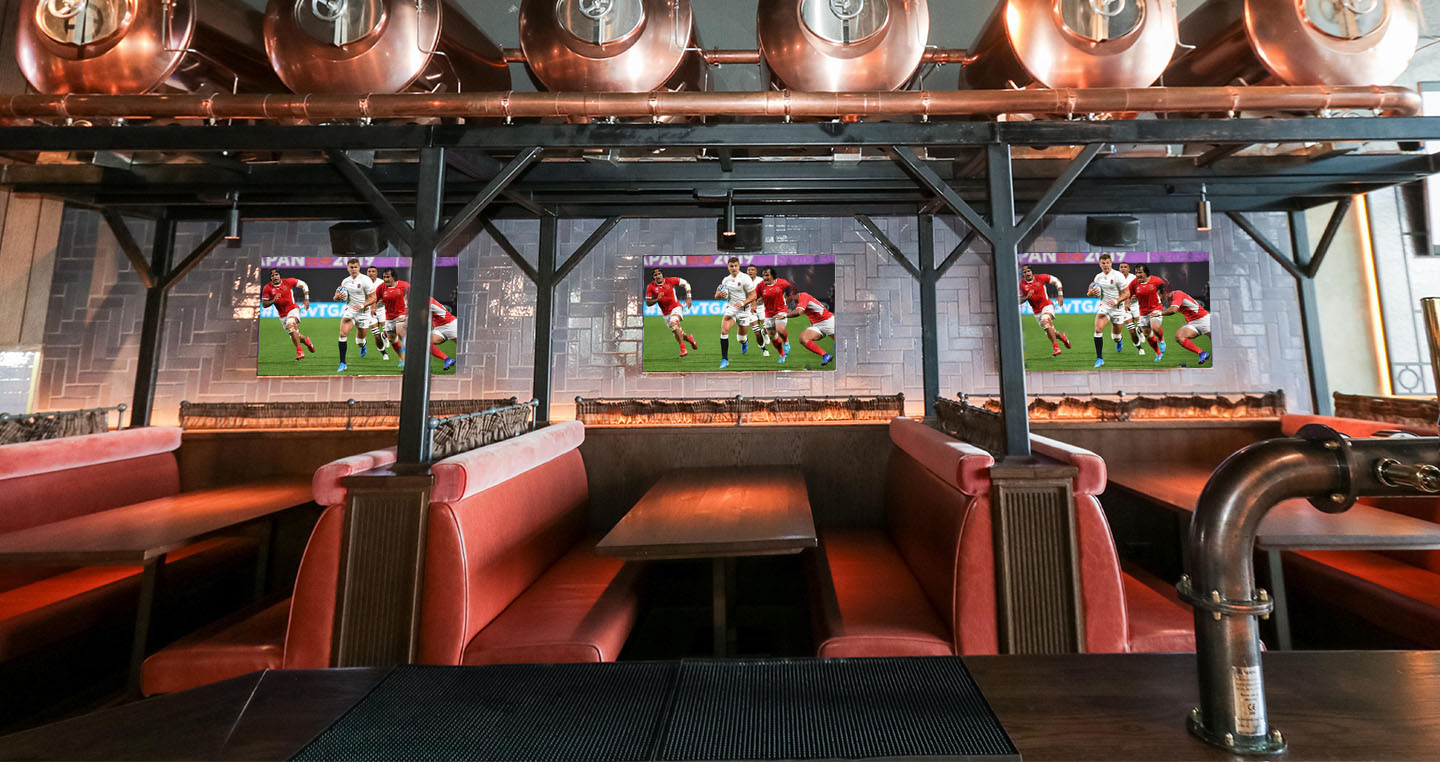 Vibrant venue with cozy booths for social gatherings and live sports events in Westwood.