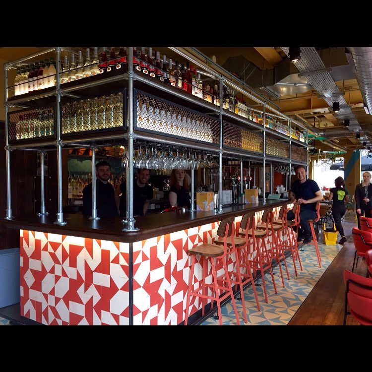 Vibrant bar setup at Las Iguanas London O2, ideal for networking events and gatherings.
