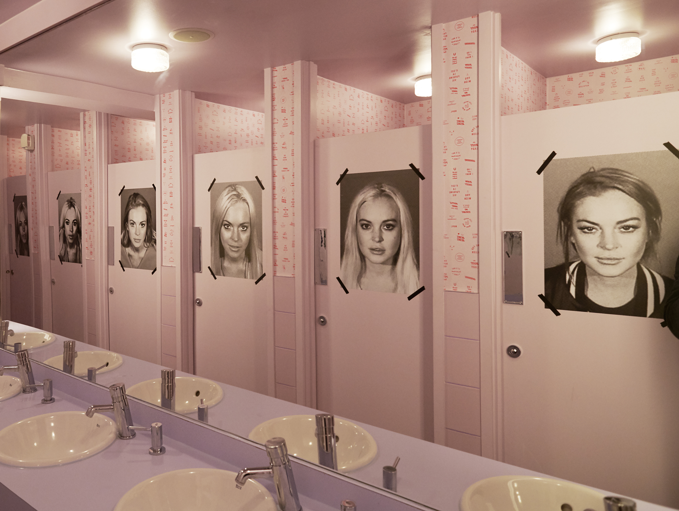 Unique restroom with black-and-white portraits at Tonight Josephine Waterloo event venue.