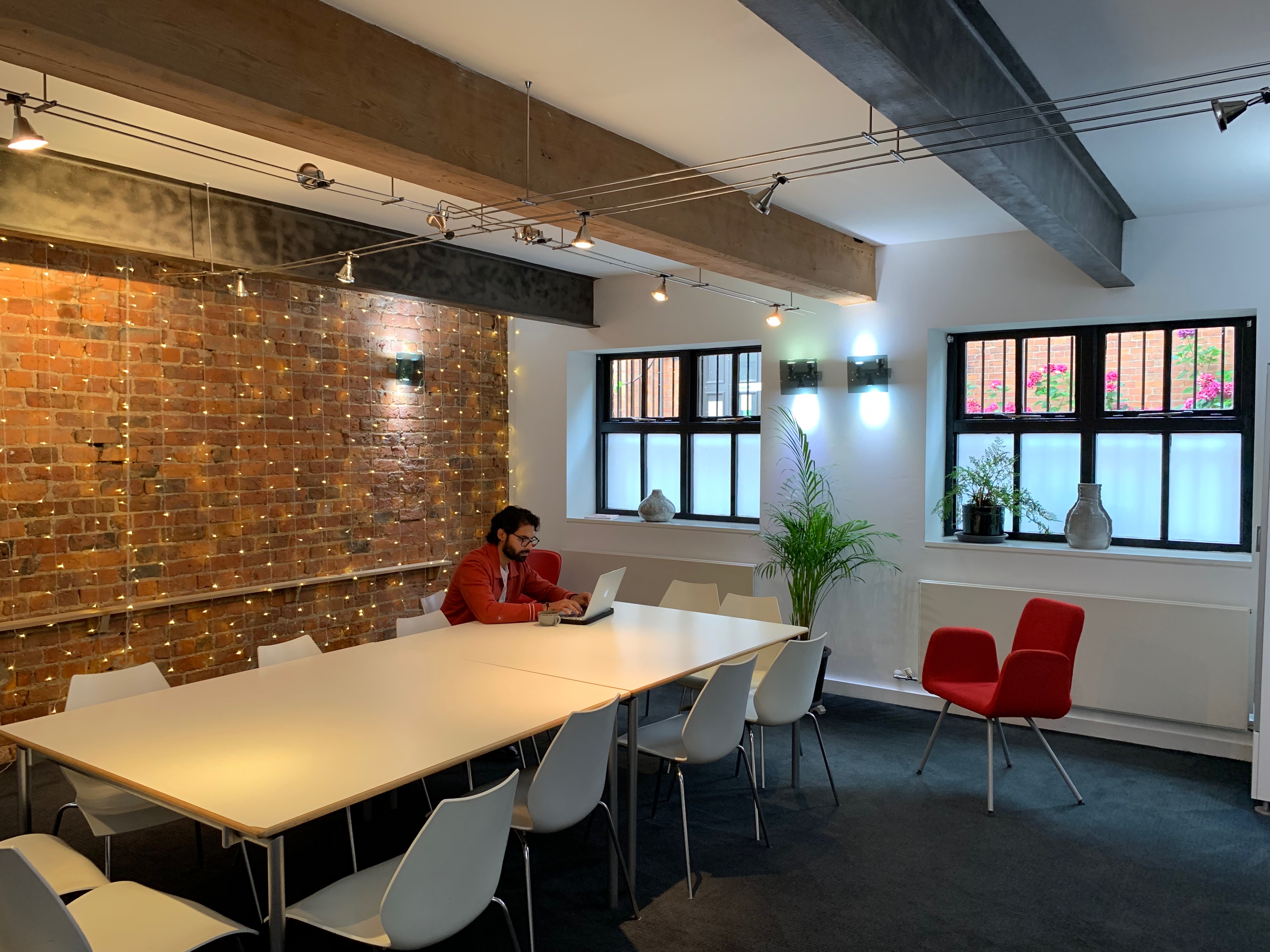 Modern boardroom with large table, ideal for meetings and collaborative sessions.