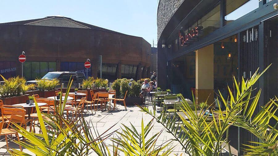 Vibrant outdoor dining area at Las Iguanas Newport for casual meetings and networking.