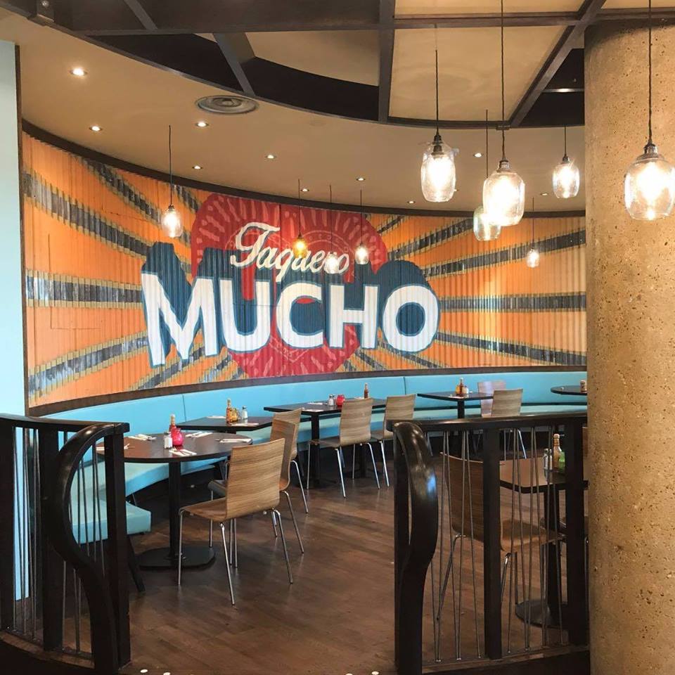 Vibrant Las Iguanas venue with bold mural, ideal for casual gatherings and events.