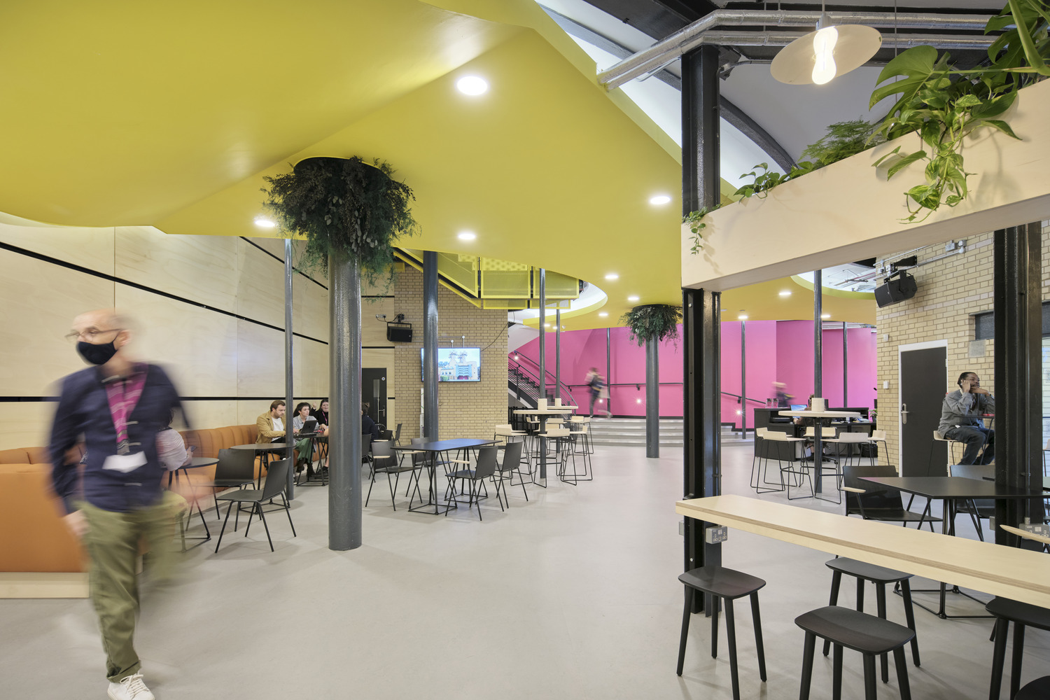 Modern event space in Contact Theatre with vibrant yellow ceiling for meetings and gatherings.