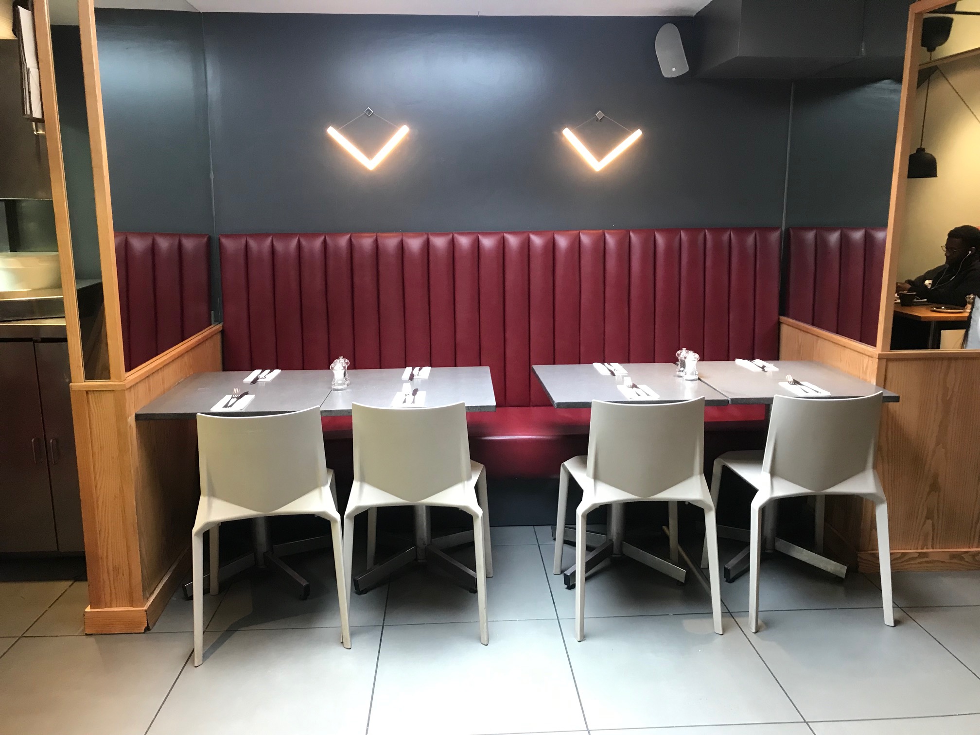 Modern dining setup with red booth, ideal for intimate meetings and events at The GOAT Chelsea.