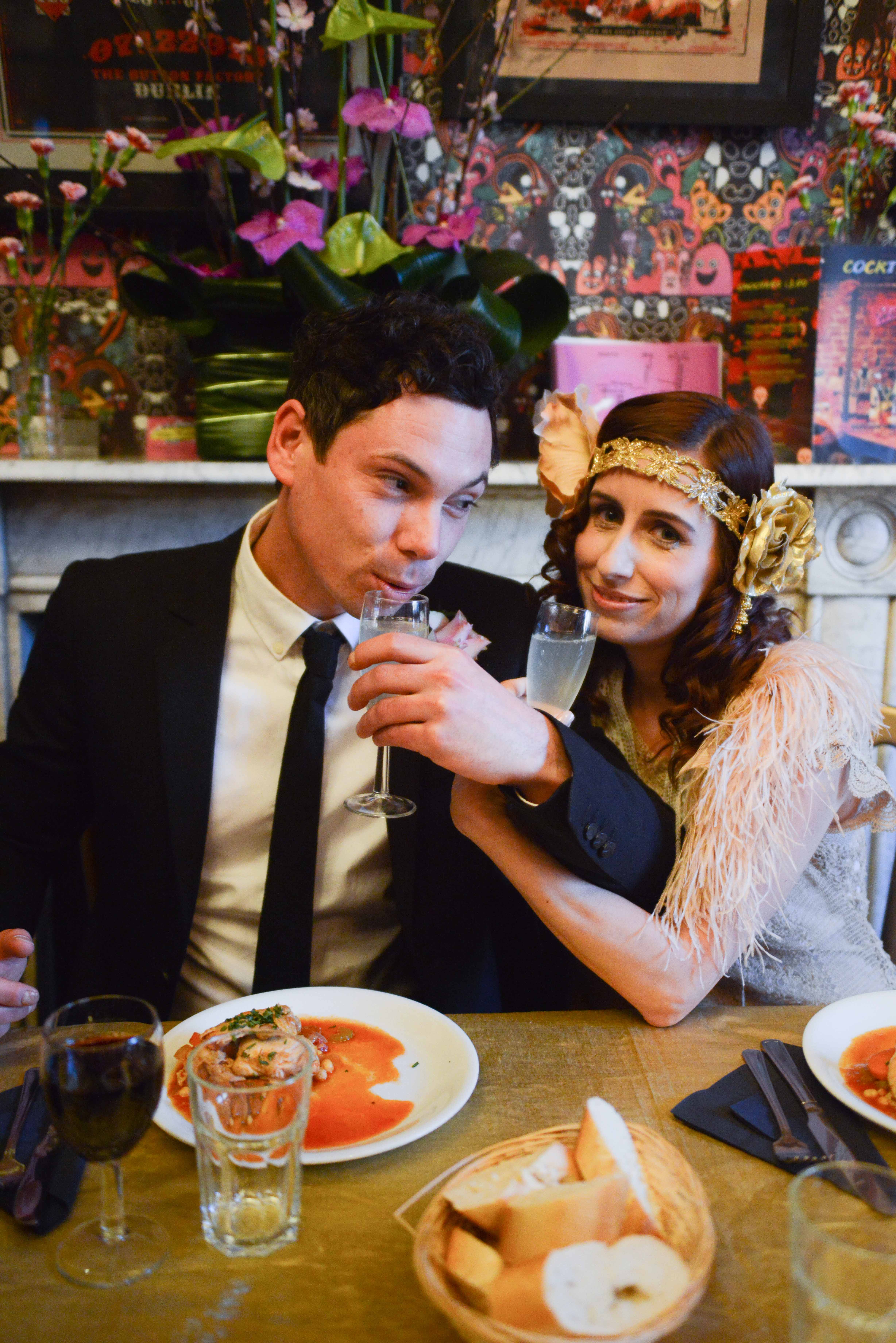 Stylish couple enjoying cocktails at Hotel Pelirocco's vibrant themed celebration.
