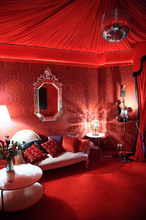 Stylish meeting room with red wallpaper, ideal for intimate events and gatherings.