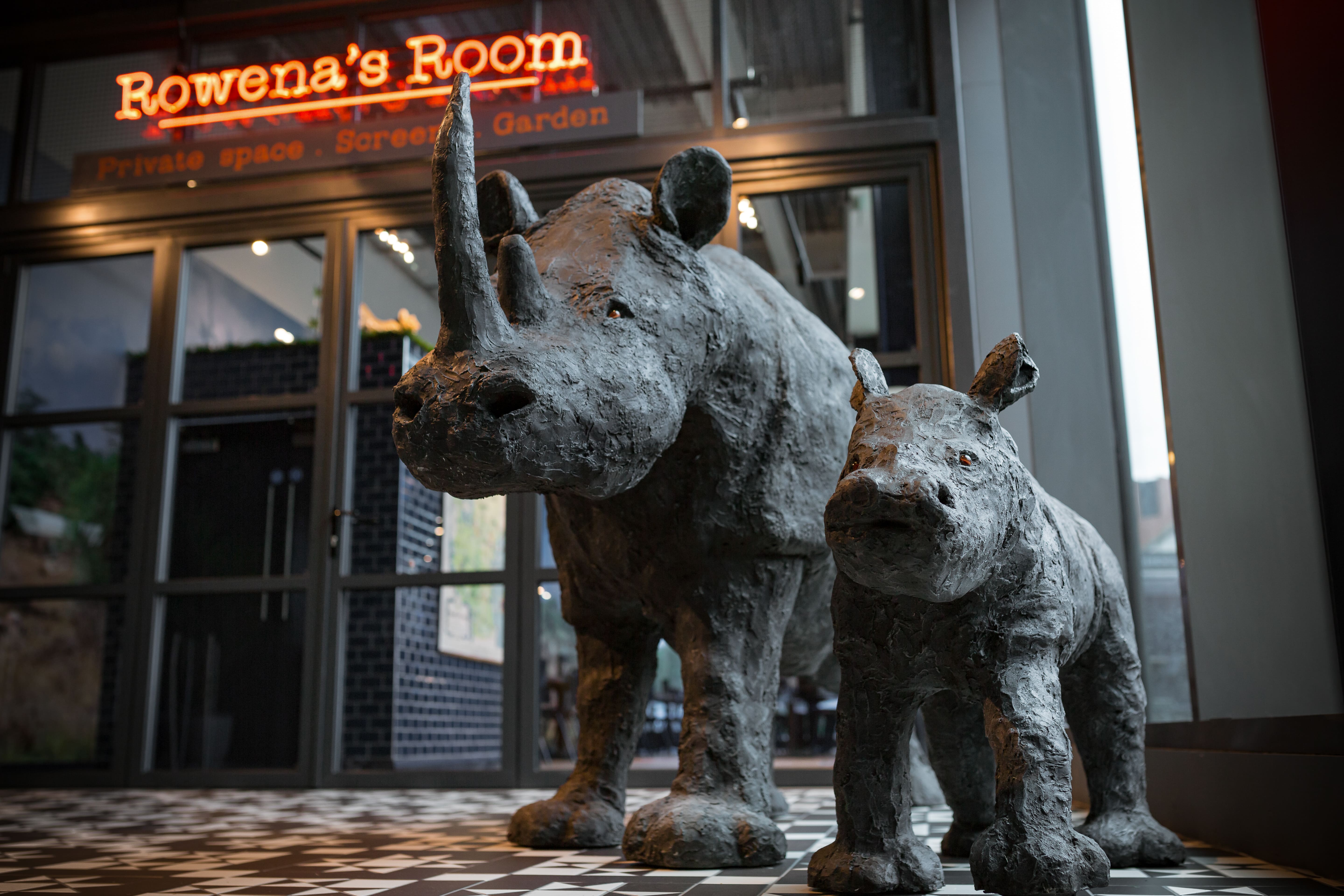 Rowena's Room entrance with rhino sculptures, ideal for creative events in Stockport.