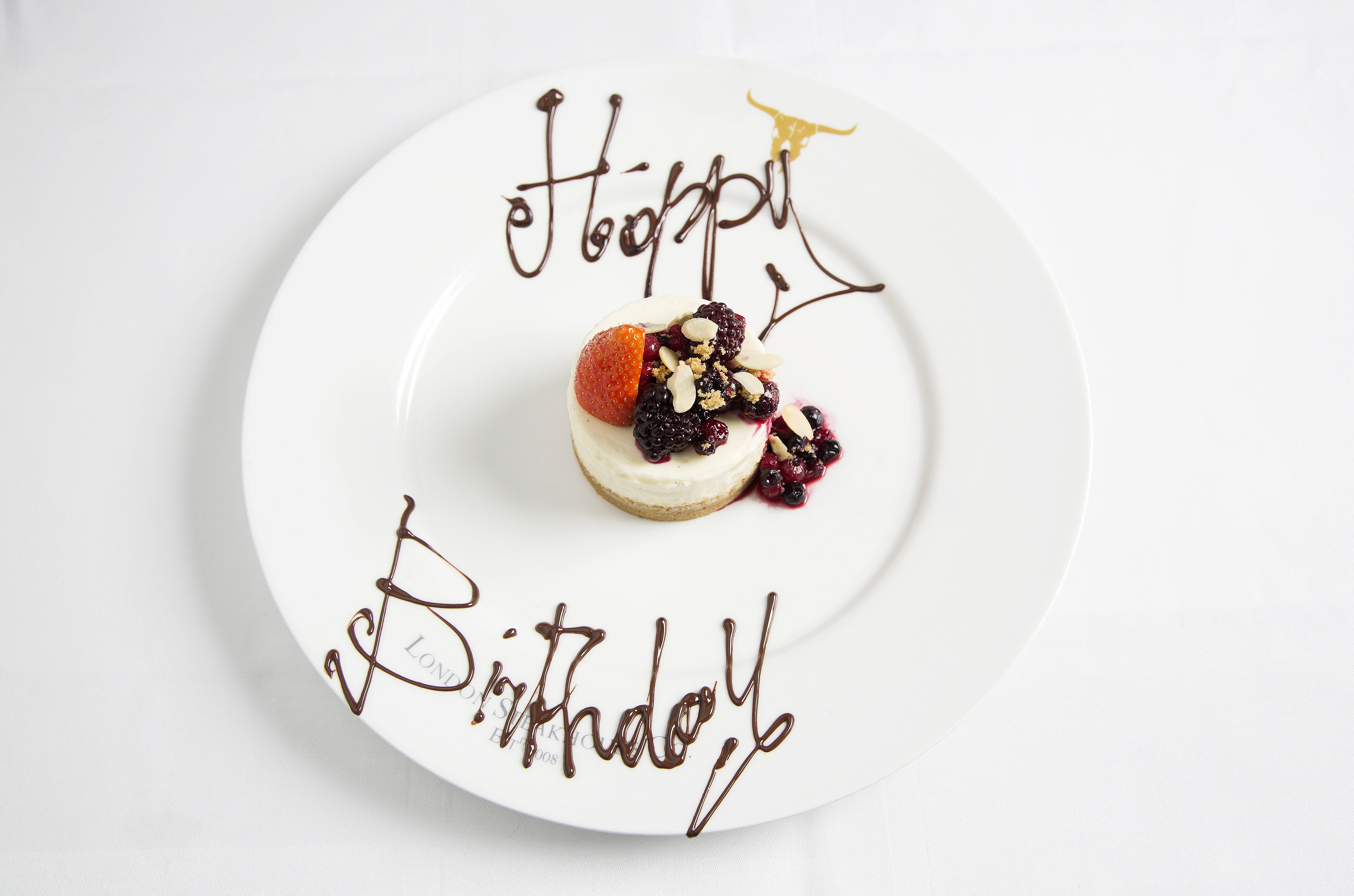 "Birthday cheesecake dessert with berries at London Steakhouse Company venue"