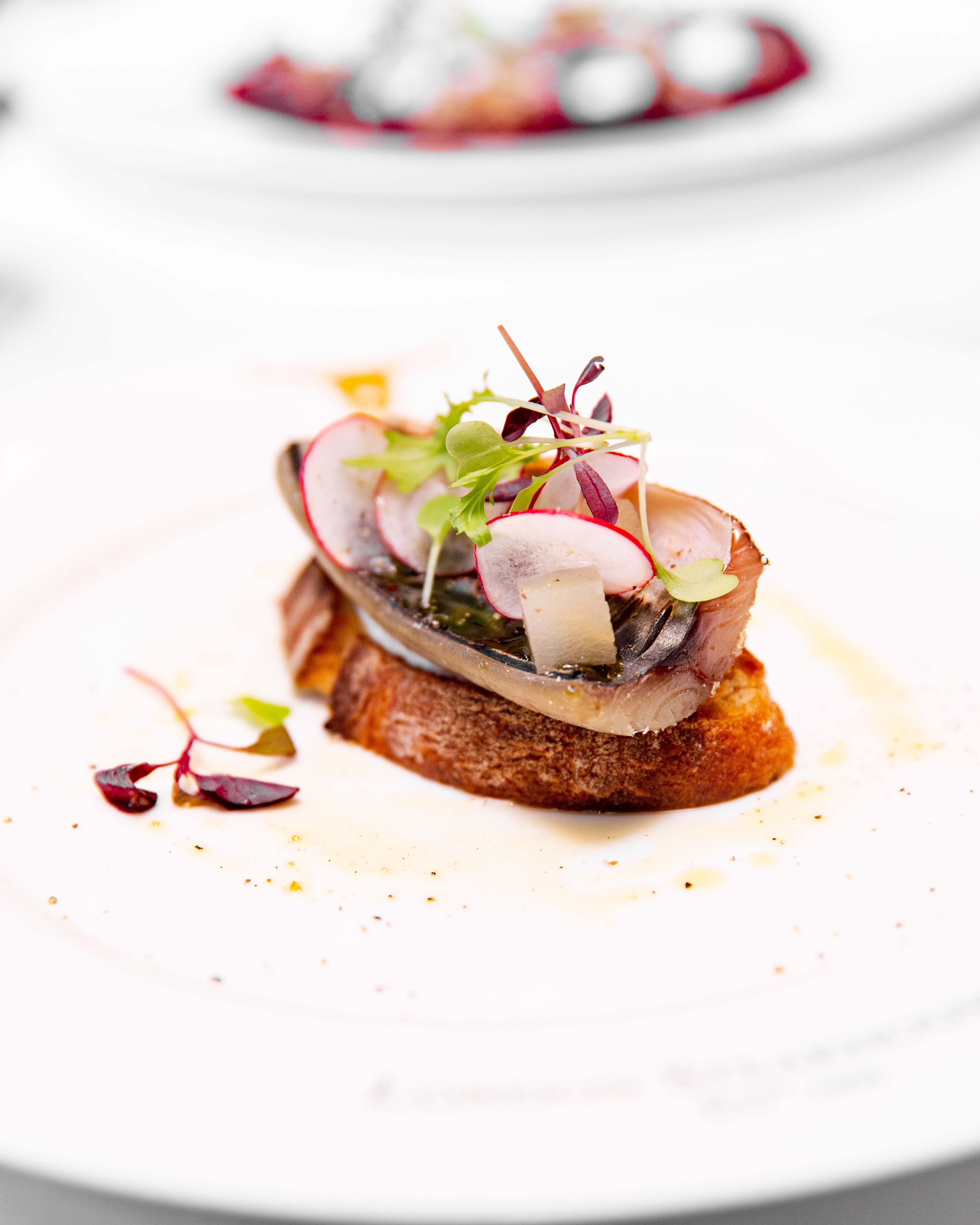 Elegant appetizer with fish on toast, ideal for upscale corporate events in London.