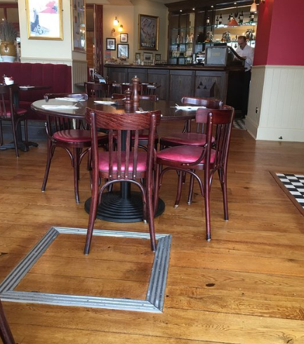 Whole Venue at Café Rouge Lakeside with wooden tables, ideal for casual events and meetings.