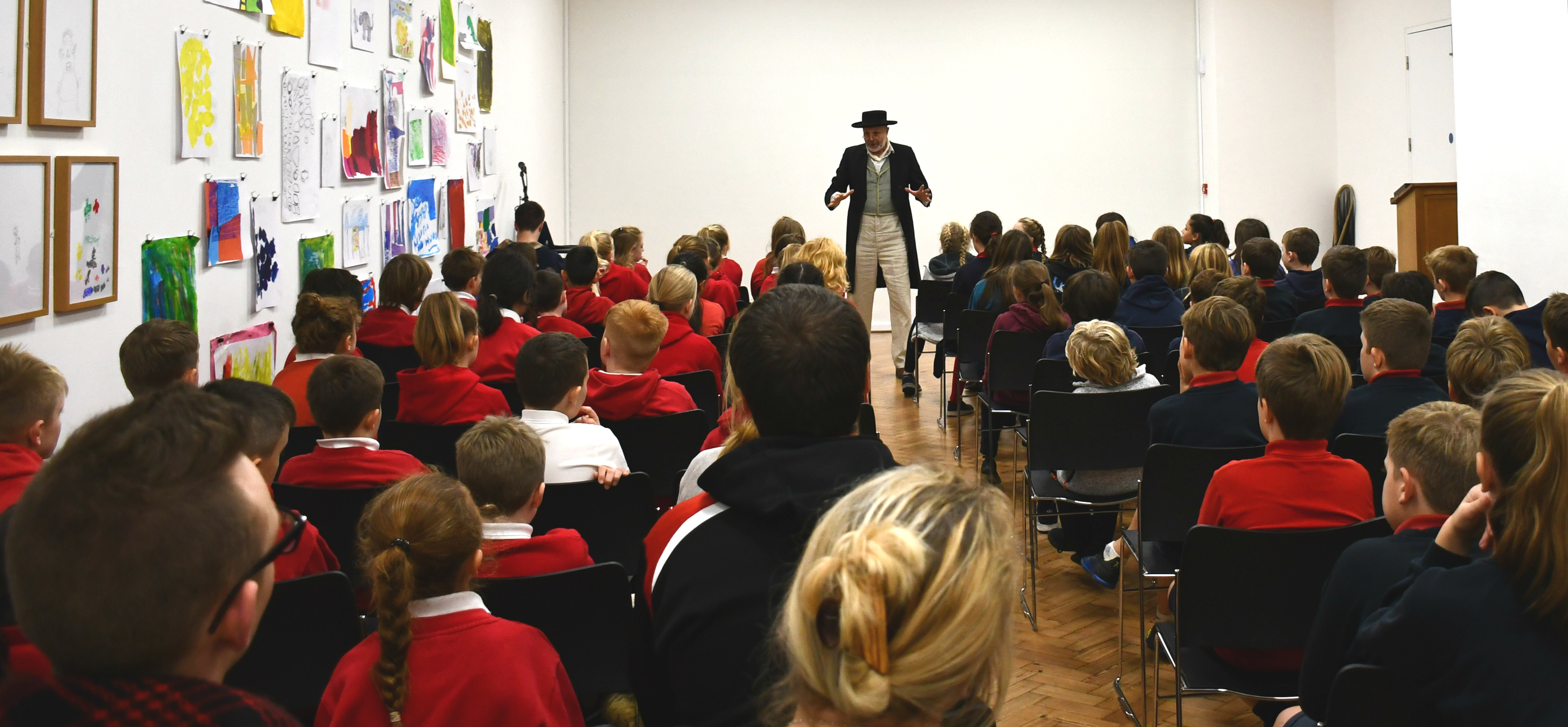 Lecture Theatre at Glynn Vivian Art Gallery with engaging speaker and colorful artwork.