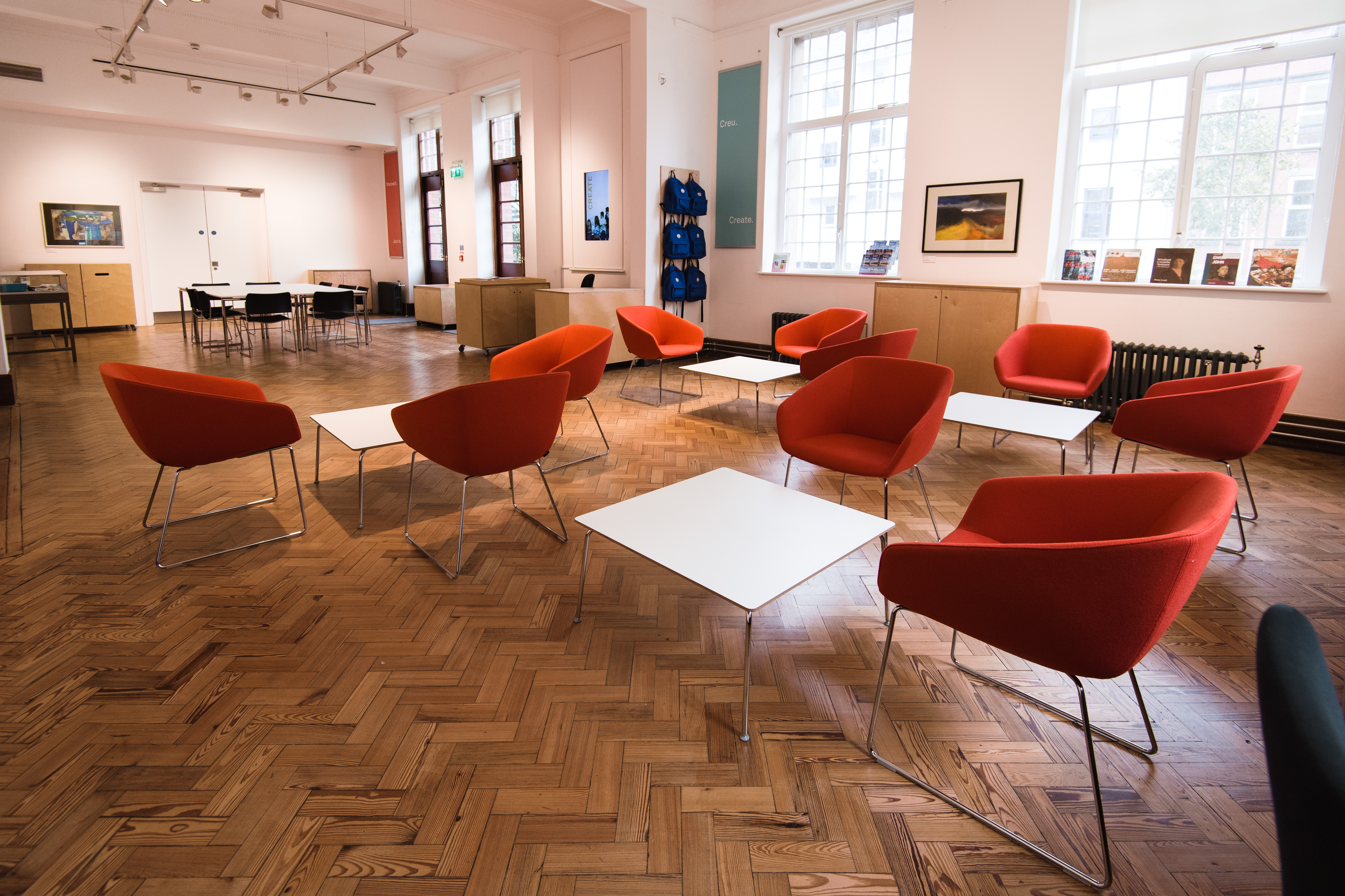 Modern Garden Room at Glynn Vivian Art Gallery with vibrant orange chairs for workshops.