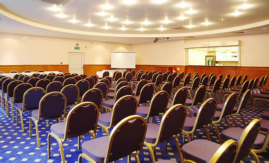 Banqueting Hall in Ealing Suite with purple chairs for a conference setup.